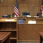 Image of a courtroom. You are looking at the judge's seat.